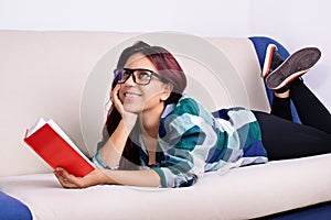 Young girl fantasizing while reading a book