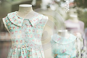 Young girl fashion dress in childrenswear fashion shop window