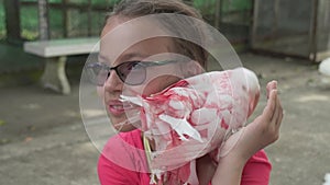 Young girl feeds ornamental pigeons with multi-colored feathers stock footage video