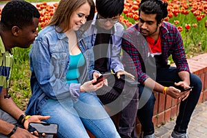 Young girl feeling happy among three multiracial male friends