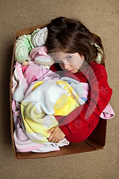 Young Girl With Fever Rash Cuddling in a Box with Stuffed Animal