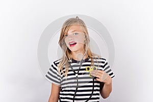 Young girl with fidget spinner as stethoscope - health concept