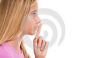 Young girl with finger on lips as concept of ordering silence i