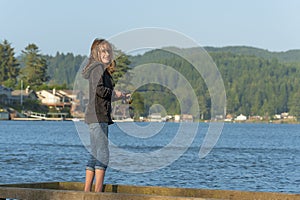 Young girl fishing off of dock