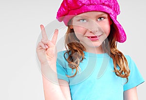 Young girl flashing peace sign