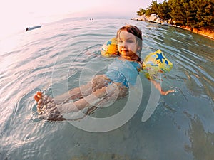 Young girl floating in shallow water