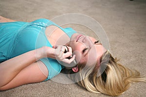 Young girl on floor talking on phone