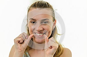 Young girl flossing her teeth