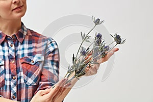 Young girl with flowers eryngium