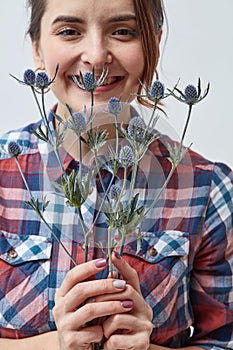 Young girl with flowers eryngium