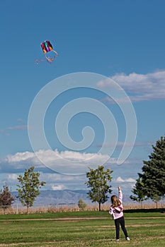 Young girl flying a kite