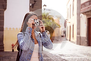 Young girl focusing her old camera