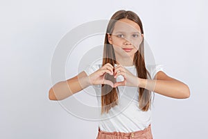 A young girl folded a heart with her hands