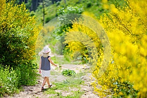Young girl following a footpath around La Verna Sanctuary, Chiusi della Verna, in Casentino secular forest, one of the largest