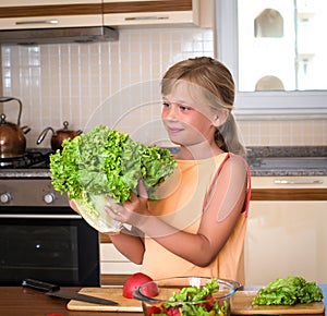 Young Girl With Fresh Lettuce. Healthy Food - Vegetable Salad. Diet. Dieting Concept. Healthy Lifestyle. Cooking At Home. Prepare