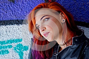 Young girl in front of graffiti