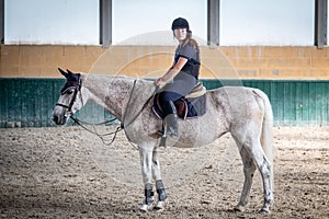 Young girl  gallops on the white horse.