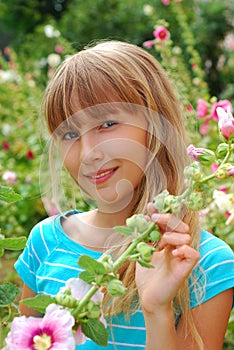 Young girl in the garden of mallows