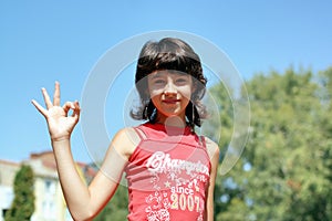 Young girl gesturing okay