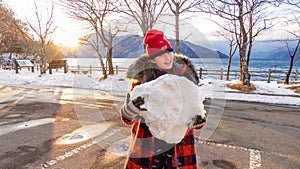 Young girl with giant snowball