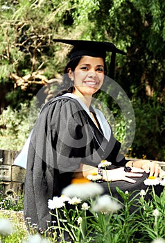 Young girl girl in a graduation gown.