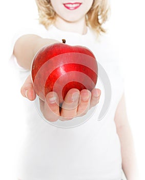 Young girl giving red apple