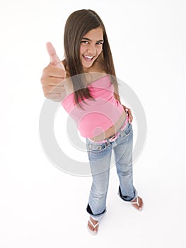 Young girl giving thumbs up smiling