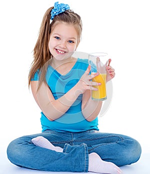Young girl with glass of orange juice.