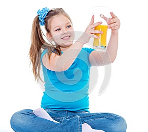 Young girl with glass of orange juice.