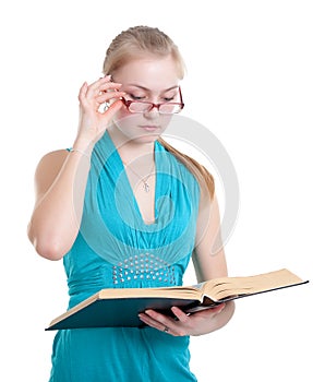 A young girl in glasses with a book