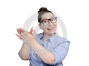 Young girl with glasses maliciously clapping her hands on white background