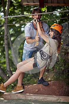 A young girl goes down the zipline. Activity, extreme, entertainment