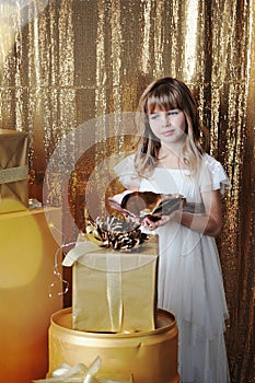 Young girl with gold gift boxes on birthday