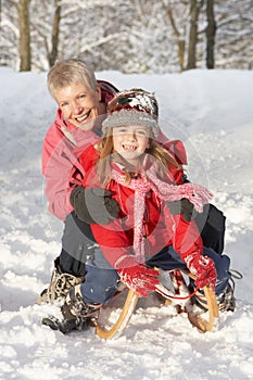 Young Girl With Grandmother Riding On Sledge photo