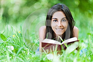 Young girl grass reading book