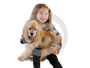 Young girl grinning as she hugs her puppy