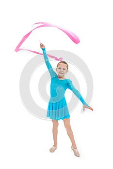 Young girl gymnast exercising with pink ribbon on white