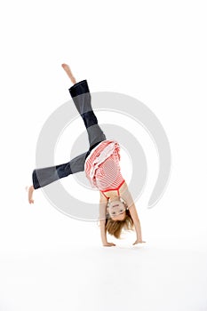 Young Girl In Gymnastic Pose Doing Cartwheel photo