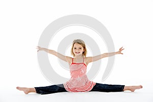 Young Girl In Gymnastic Pose Doing Splits photo