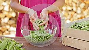 Young girl hands stirring peas in glass bowl