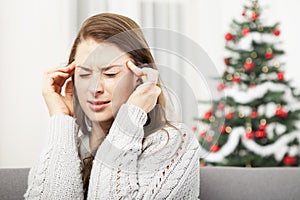 Young girl has headache of christmas stress