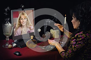 Young girl has video chat with modern witch photo