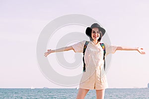 Young girl with hat smiling happy with open arms