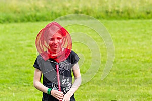 Young girl have fun with a butterfly net on the meadow