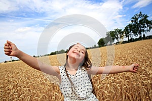 Young girl have fun in wheat field