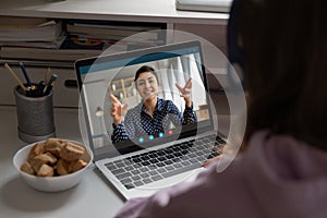 Young girl have video call with teacher at home