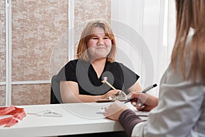 Young girl having appointment with doctor in her office