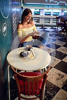 Young girl having coffee in a bar