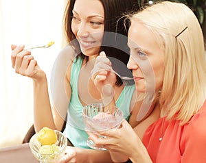 Young girl having coffee break and eating ice cream