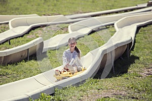 Young girl having fun riding a outdoor coaster ride